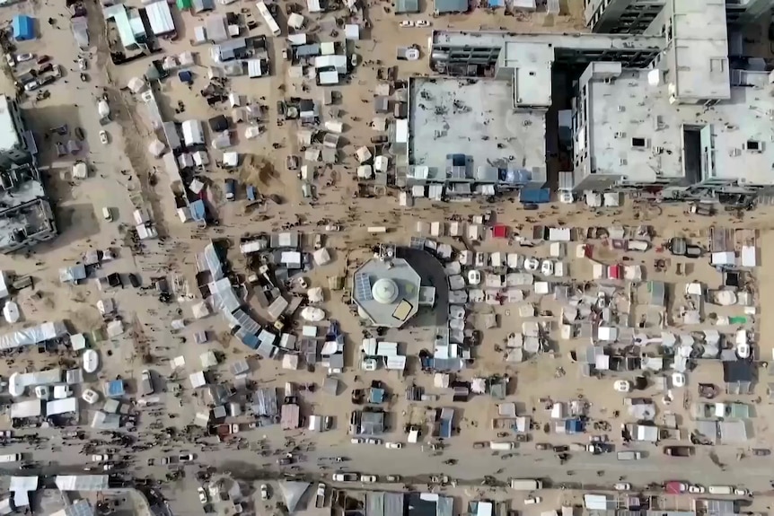 aerial of a street in gaza crowded with tents and refugee structures 