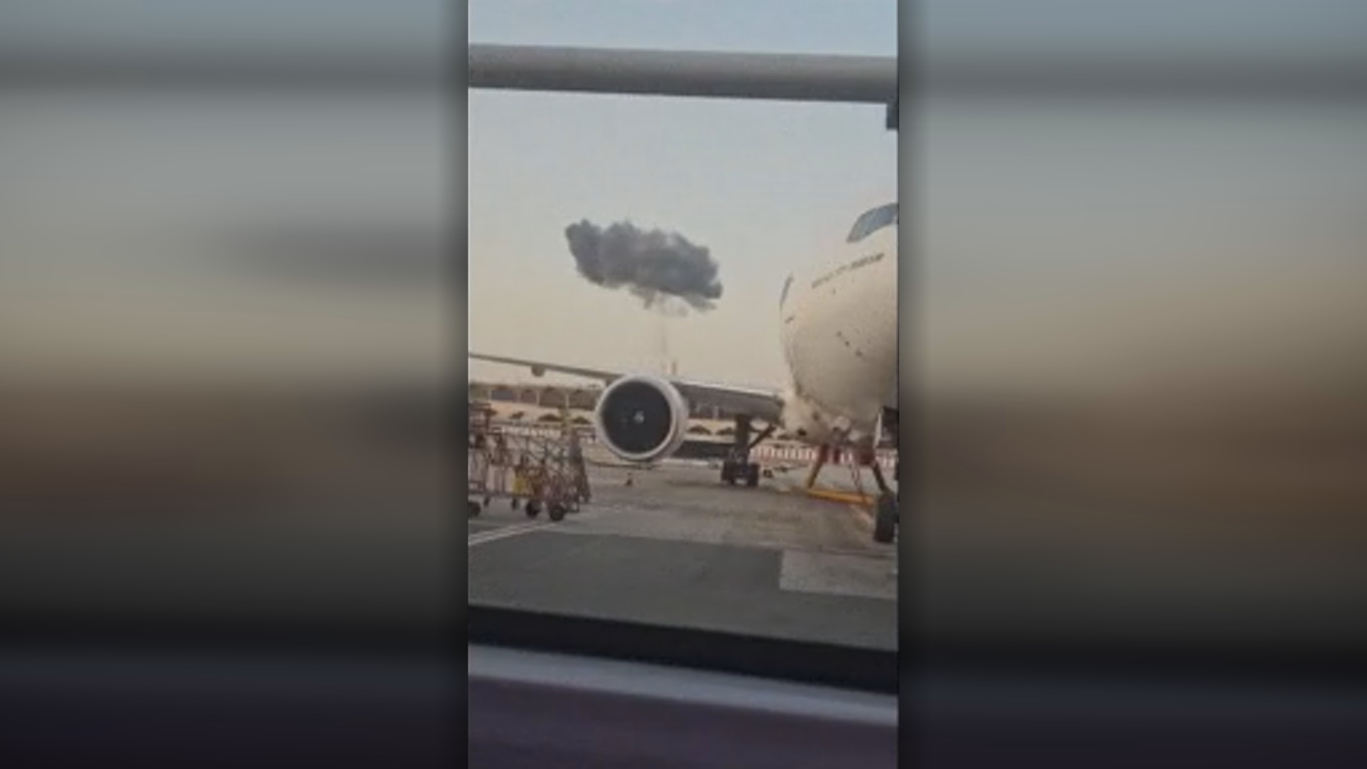 A cloud of black smoke seen from the tarmac of the airport