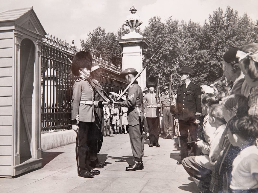 An Australian soldier and a British palace guard.