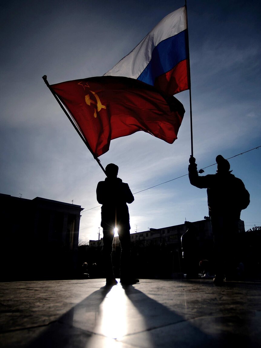 Men wave Russian flags in Crimea