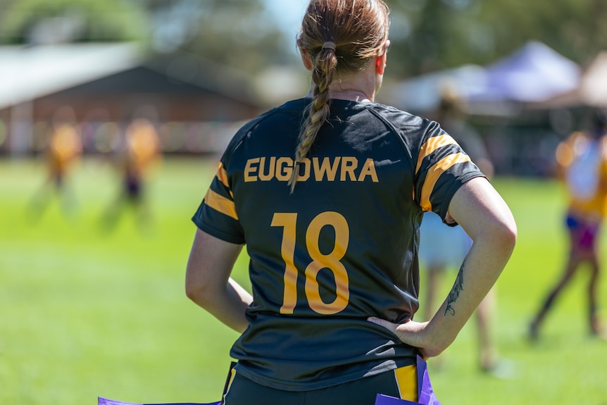 The back of a woman's black rugby jersey 