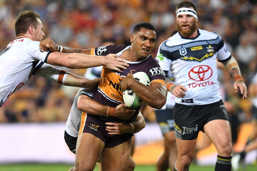 Tevita Pangai Junior tries to fend off Michael Morgan with his right hand, as he carries the ball in his left hand.