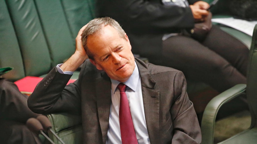 Opposition Leader Bill Shorten leans on his right arm against his head during Parliament