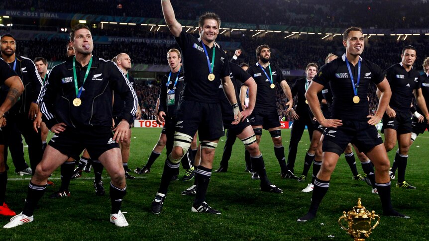 Time to party ... All Blacks captain Richie McCaw leads pitch-side celebrations after New Zealand finally ended its World Cup drought.