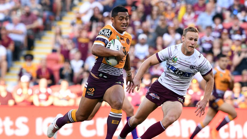 Anthony Milford runs past Daly Cherry-Evans in the Broncos versus Sea Eagles NRL match.