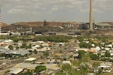 Main streets of city of Mount Isa in north-west Qld, with mine and smokestack in background