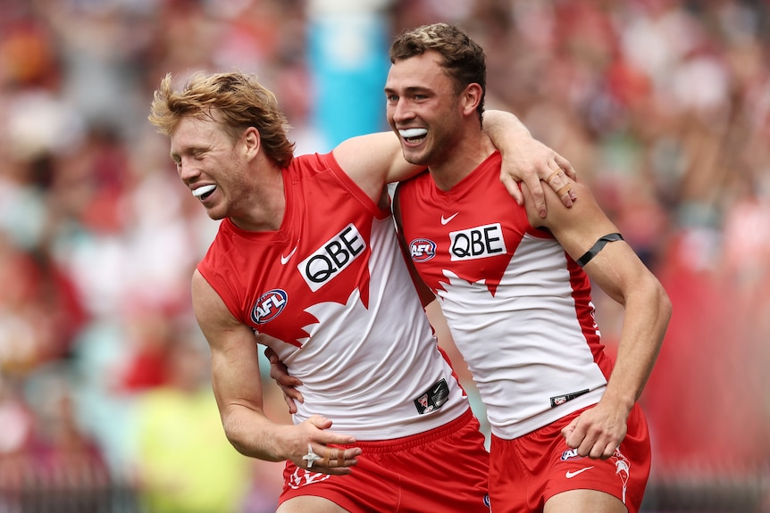 Callum Mills and Will Hayward have an arm around one another while smiling