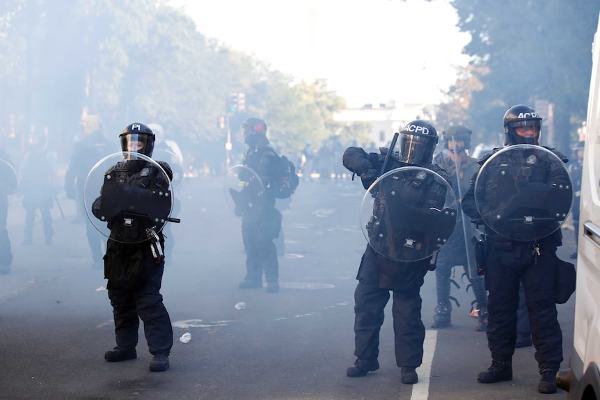 Police clear demonstrators from Lafayette Park as they protest the death of George Floyd, Monday, June 1, 2020, in Washington.