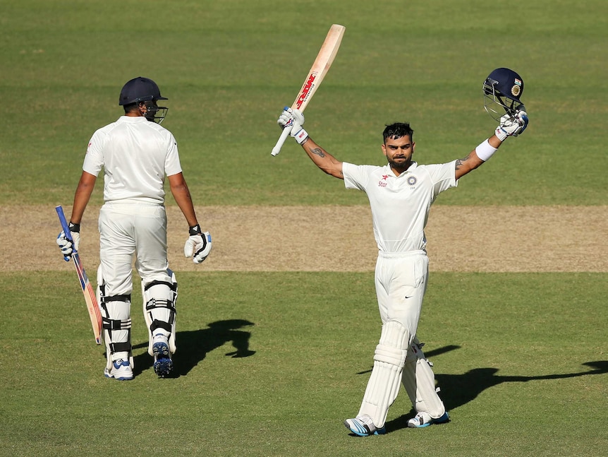 Virat Kohli of India celebrates after reaching 100 runs during day three of the First Test match between Australia and India at Adelaide Oval