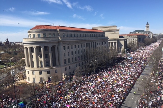 Masses of people pack into a long street in Washington during a rally.