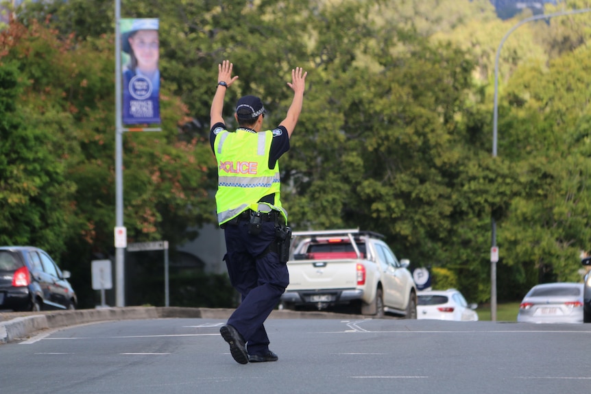 Police officer directs traffic amid power outage in Alderley