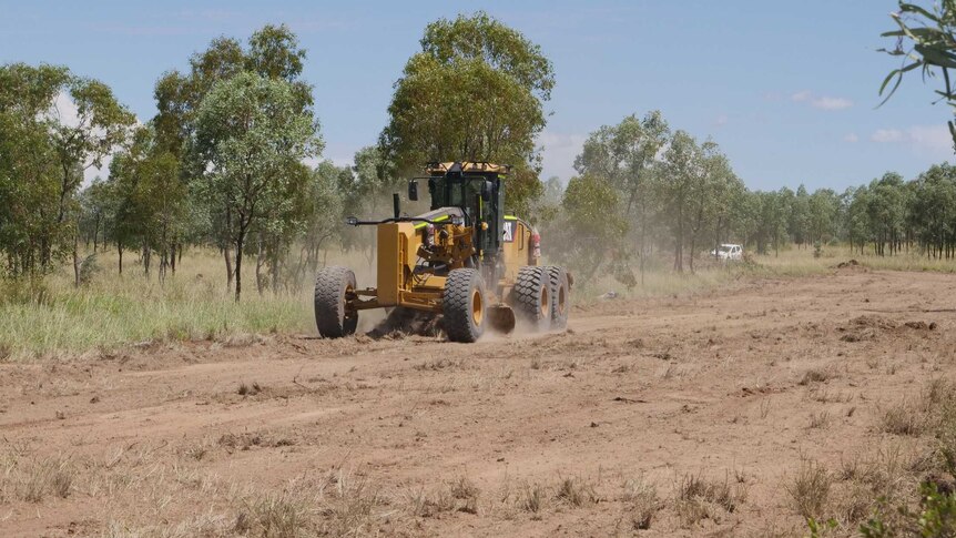 A grader doing preliminary work to the section of ground which will be the first to be dug if the mine achieves final approval