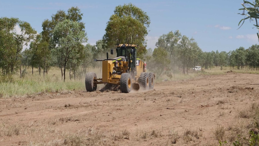 A grader doing preliminary work to the section of ground at Adani's Carmichael coal mine.