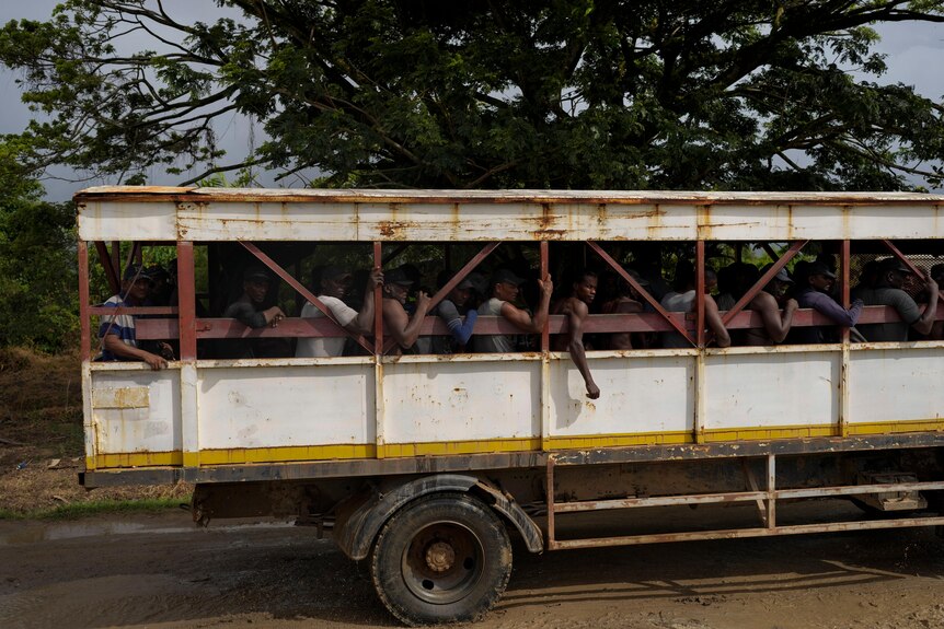 A truck with multiple people in it.