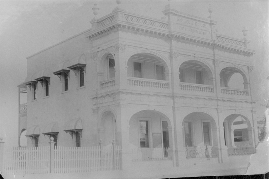 A mostly white photo of the two-storey Harbour Board building.