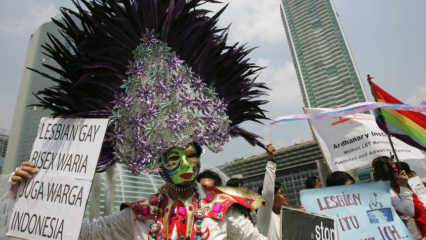 A transsexual holds a placard during an International Day Against Homophobia demonstration in Jakarta.