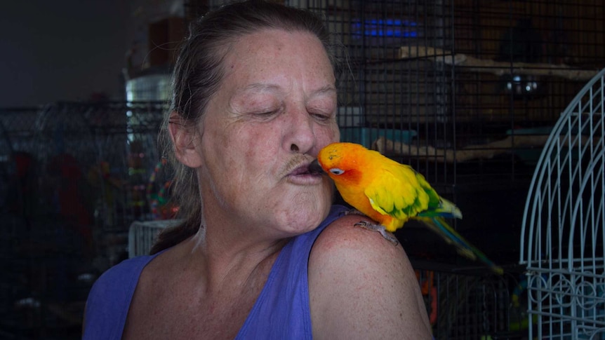 Lyn John kissing a bird