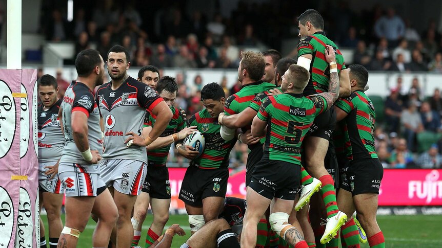 The Rabbitohs celebrate a try by Tim Grant