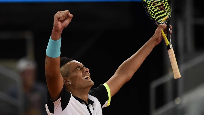 Nick Kyrgios celebrates his win over Roger Federer