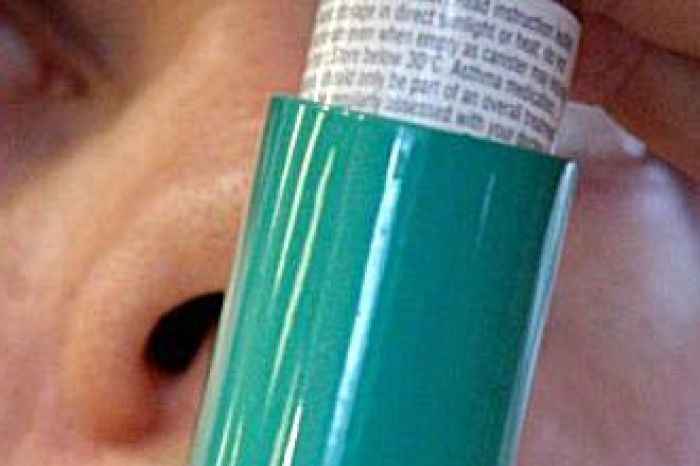 An asthma inhaler being used.