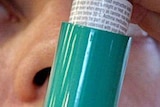 Asthma inhaler being used.