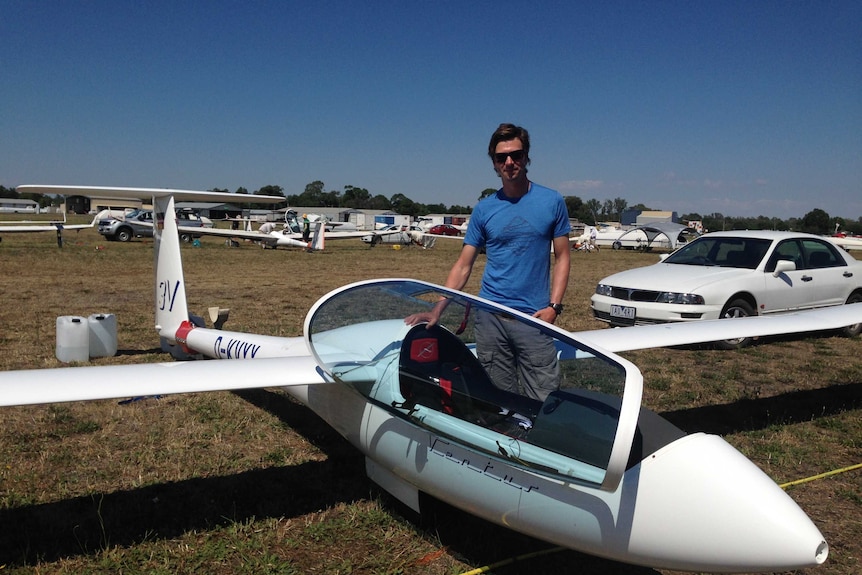 Austrian pilot, Andreas Lutz, stands next to his glider on the ground in Benalla before practise