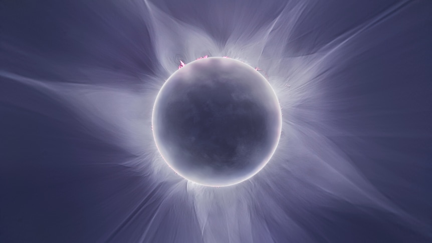The moment of a total solar eclipse, with the corona appearing around the moon and sun