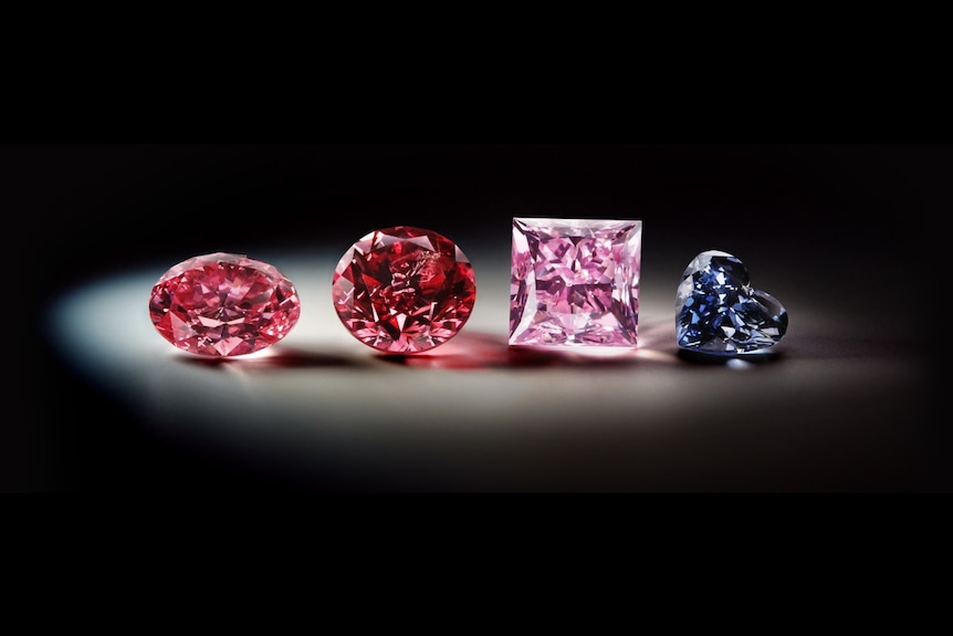 Four diamonds, with three in shades of pink and one blue.