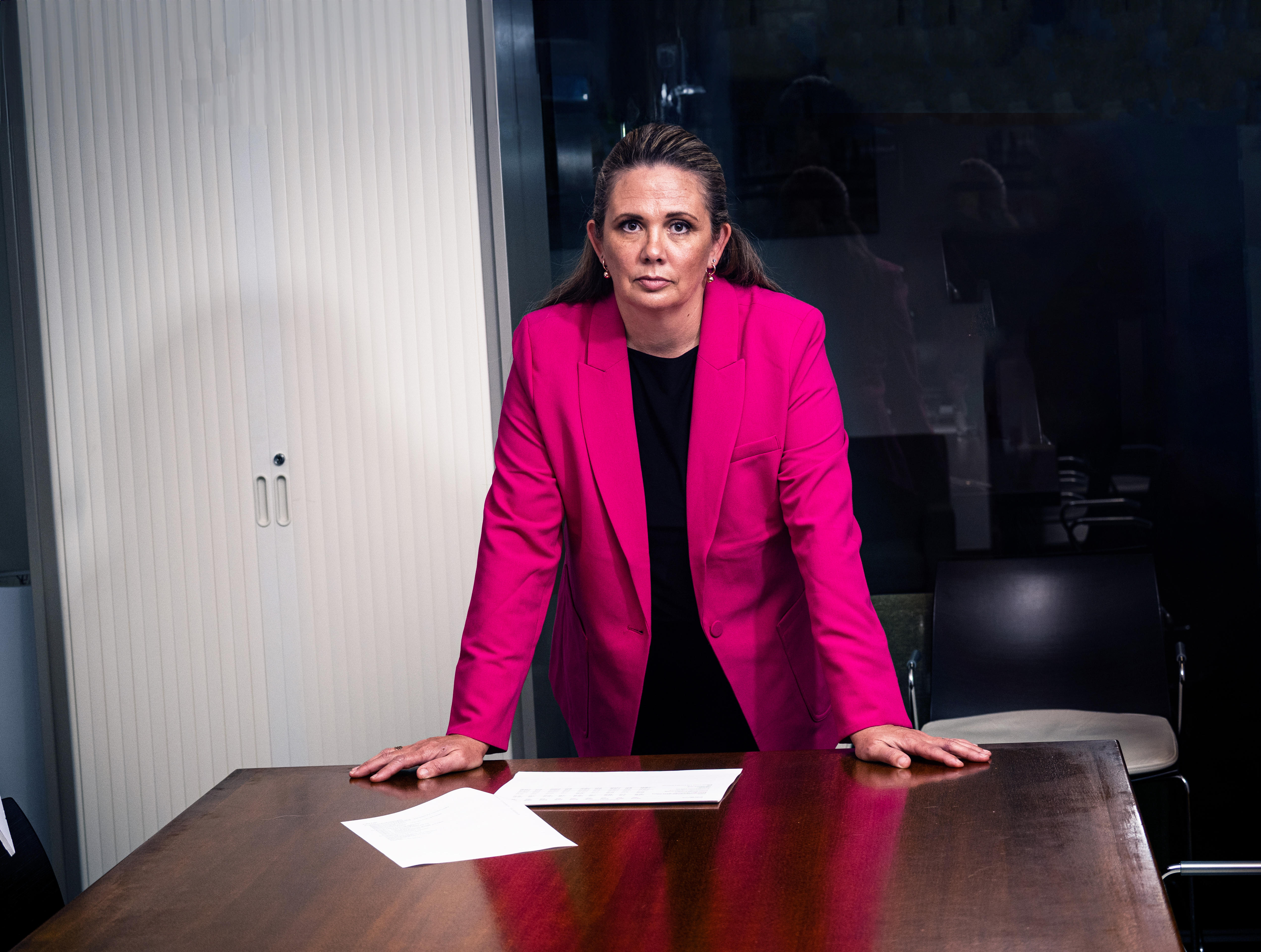 An angry woman over a desk