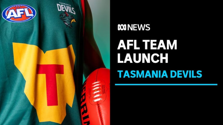 AFL Team Launch, Tasmania Devils: Close up of someone wearing a Tasmania Decils AFL jersey and holding a ball.