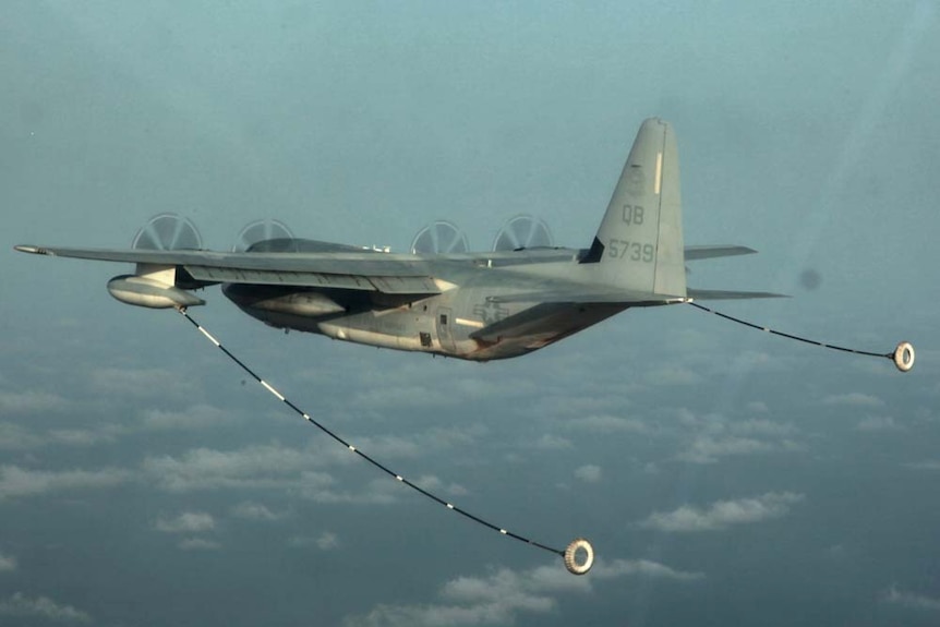 A KC-130 Hercules refuels in mid-air.