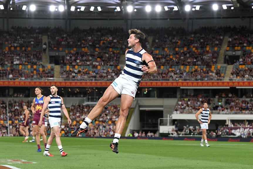 Geelong's Tom Hawkins watches his kick in the preliminary final against the Brisbane Lions.