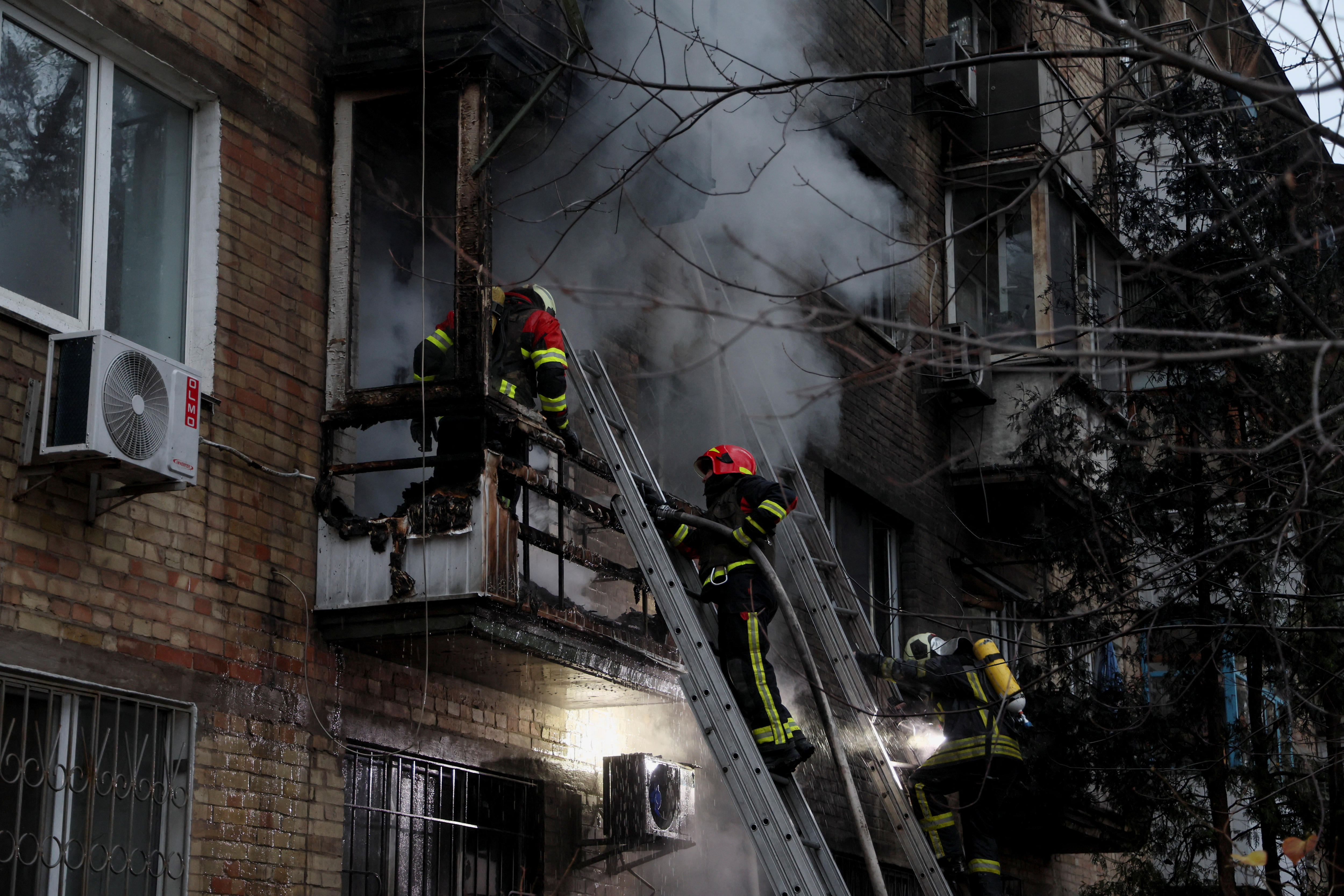 Firefighters work to put out a fire in a residential building.