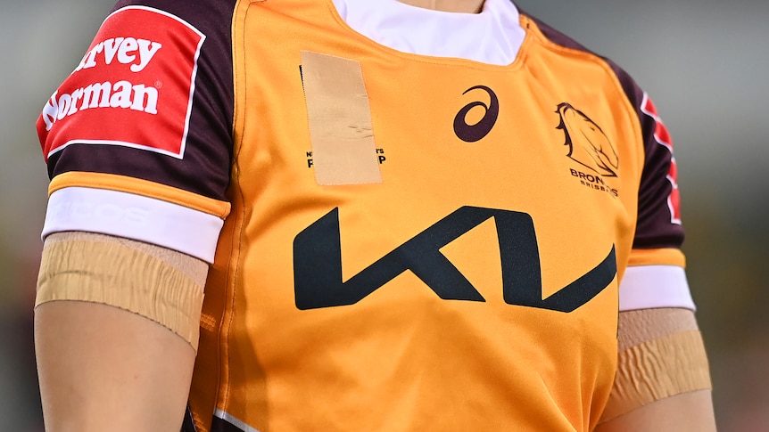 A picture of a football jersey with a logo taped over.