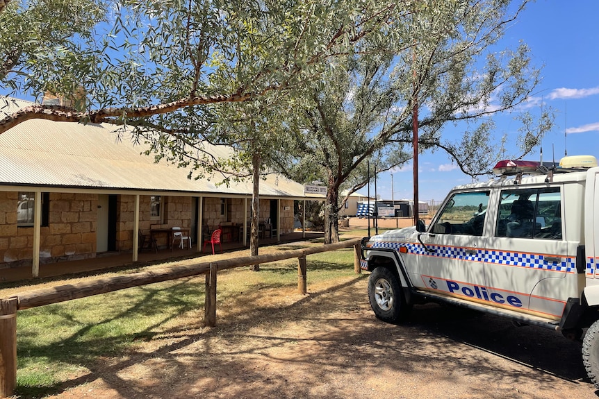 Police vehicle parked outside outback pub.