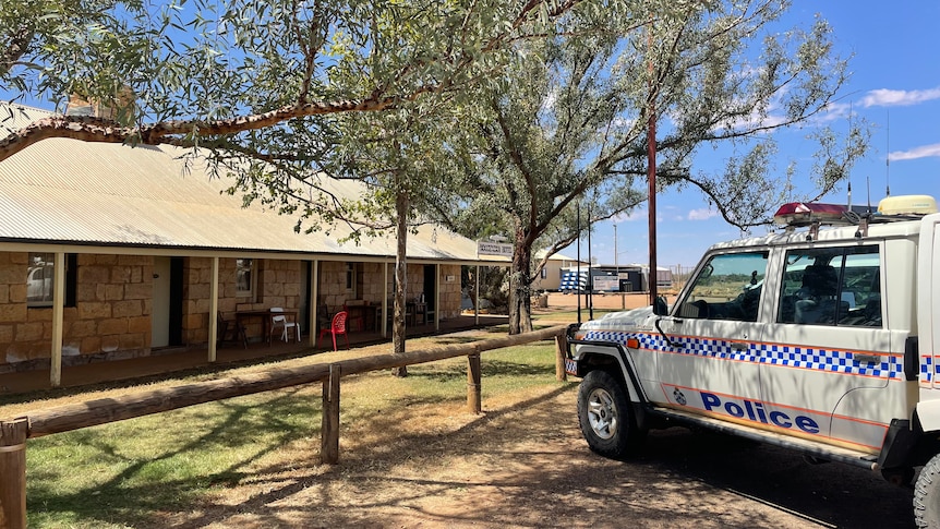 Police vehicle parked outside outback pub.