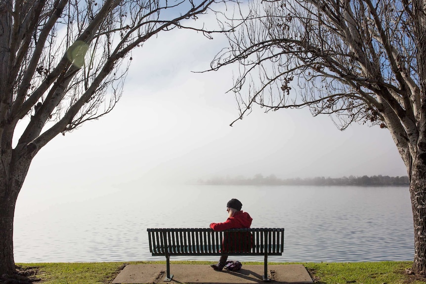 Sue Erben sits on a bench beside Lake Mulwala in Yarrawonga.