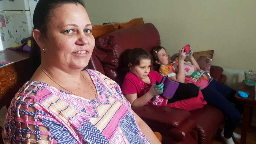 Michelle Sheean sits next to her two children.