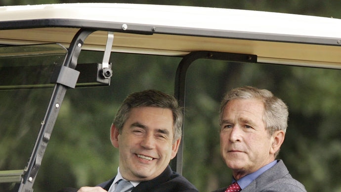 US President George W Bush gives British Prime Minister Gordon Brown a ride in his golf cart.