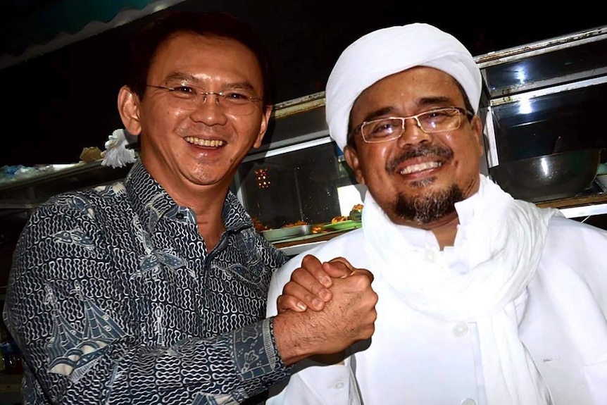 Former Jakarta GovernorAhok and Rizieq Shihab smile and shake hands in a fake, doctored photo.