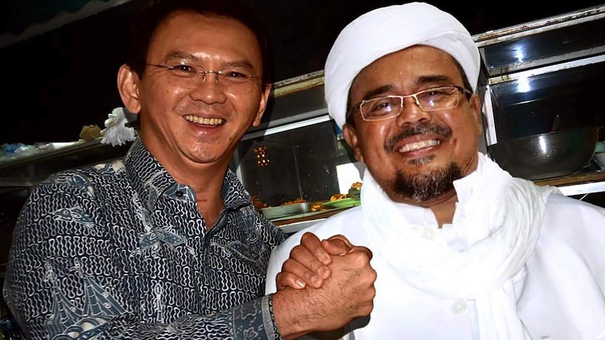 Former Jakarta GovernorAhok and Rizieq Shihab smile and shake hands in a fake, doctored photo.