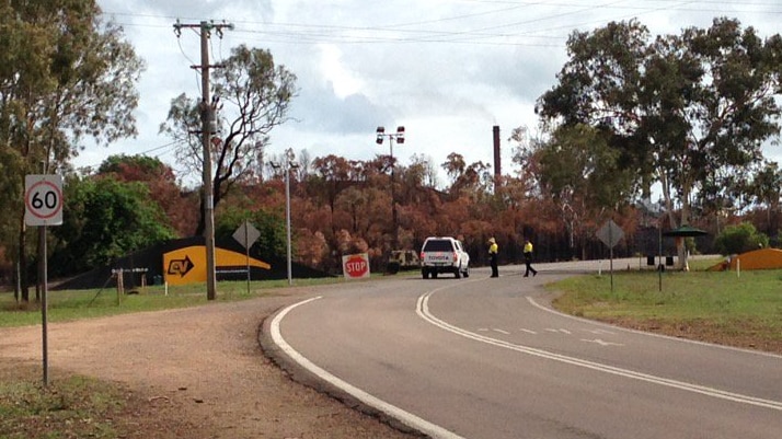 Security personnel stop cars outside Queensland Nickel, 25 kilometres nort-west of Townsville.