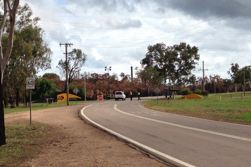 Security personnel stop cars outside Queensland Nickel, 25 kilometres nort-west of Townsville.