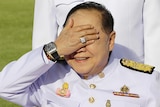 Prawit Wongsuwan shields his eyes from the sun, revealing the $100,000 watch that started the scandal.