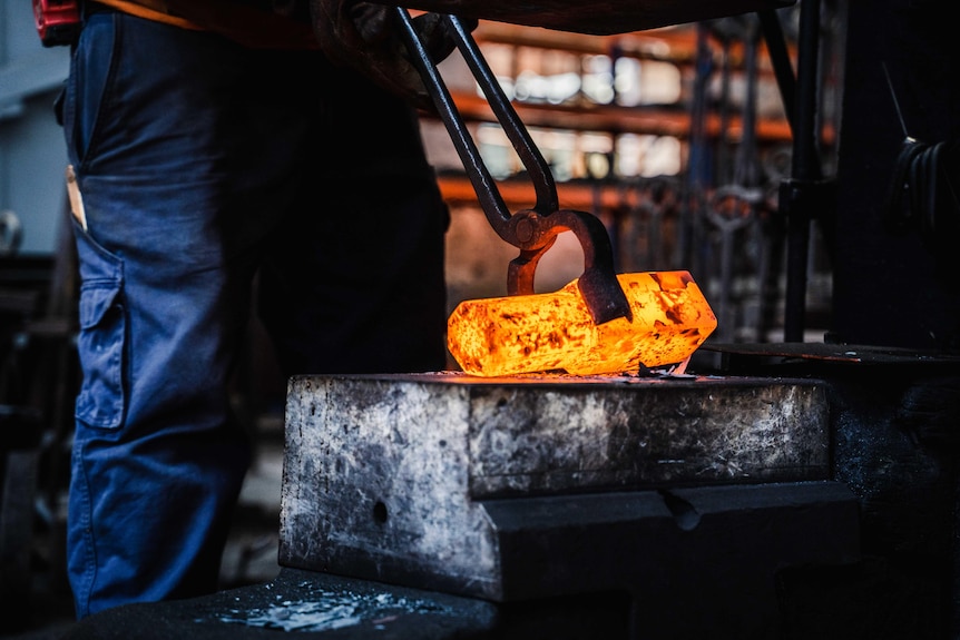 A piece of hot metal glowing orange