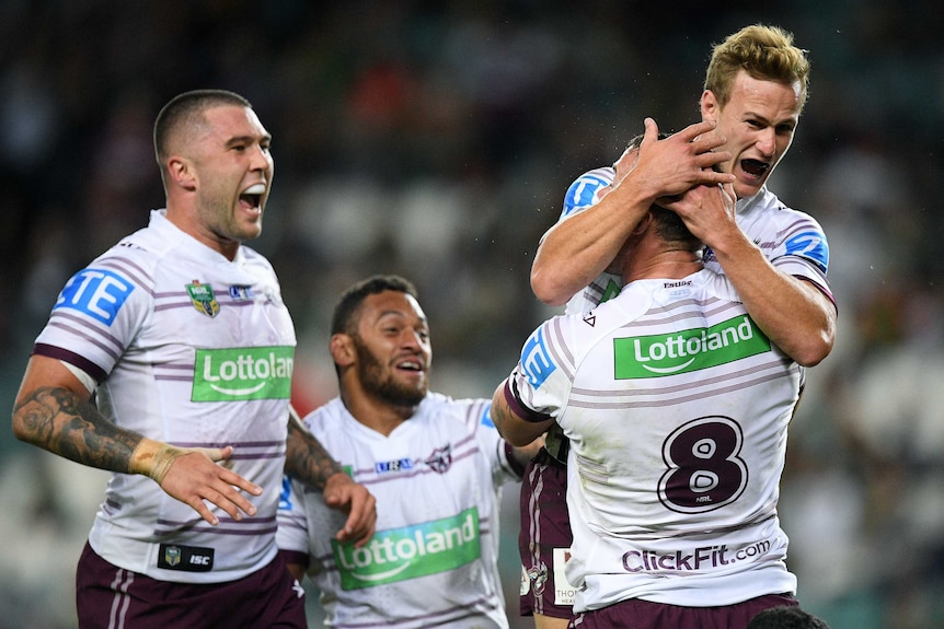 Daly Cherry-Evans (C) and the Sea Eagles celebrate a try in the victory over the Rabbitohs.