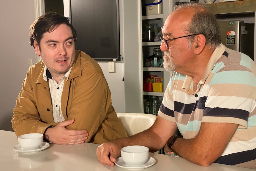 Ben Horn discusses his financial situation with his father in law on a table.