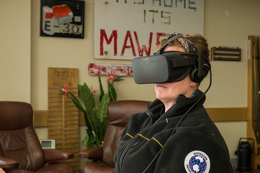 Antarctic scientist wears a virtual reality headset