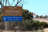 Roadside sign for Wudinna in South Australia, on a bend in the road.