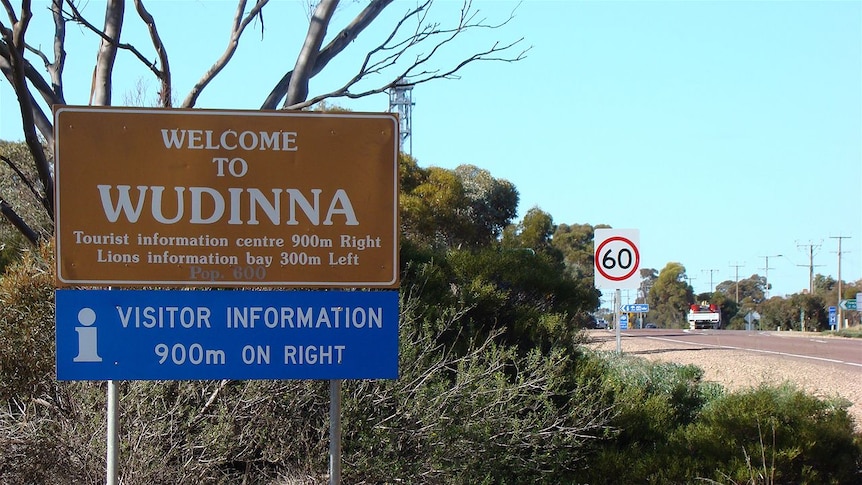 Roadside sign for Wudinna in South Australia, on a bend in the road.